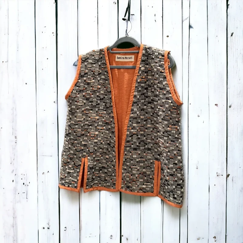 orange ember vest on the withe wall