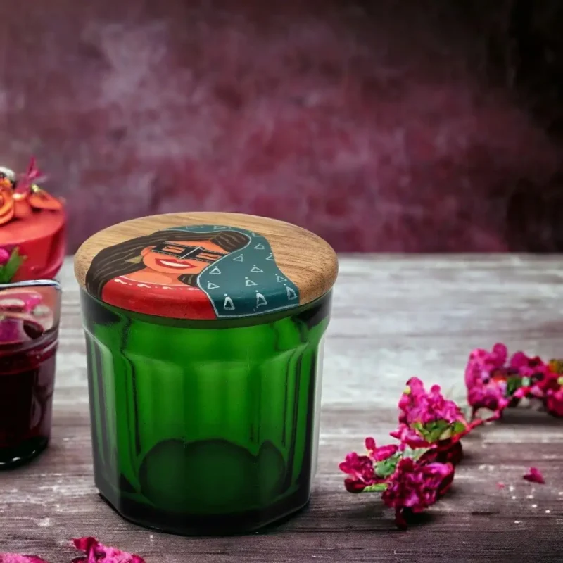 green jar and wooden lid with hand painting