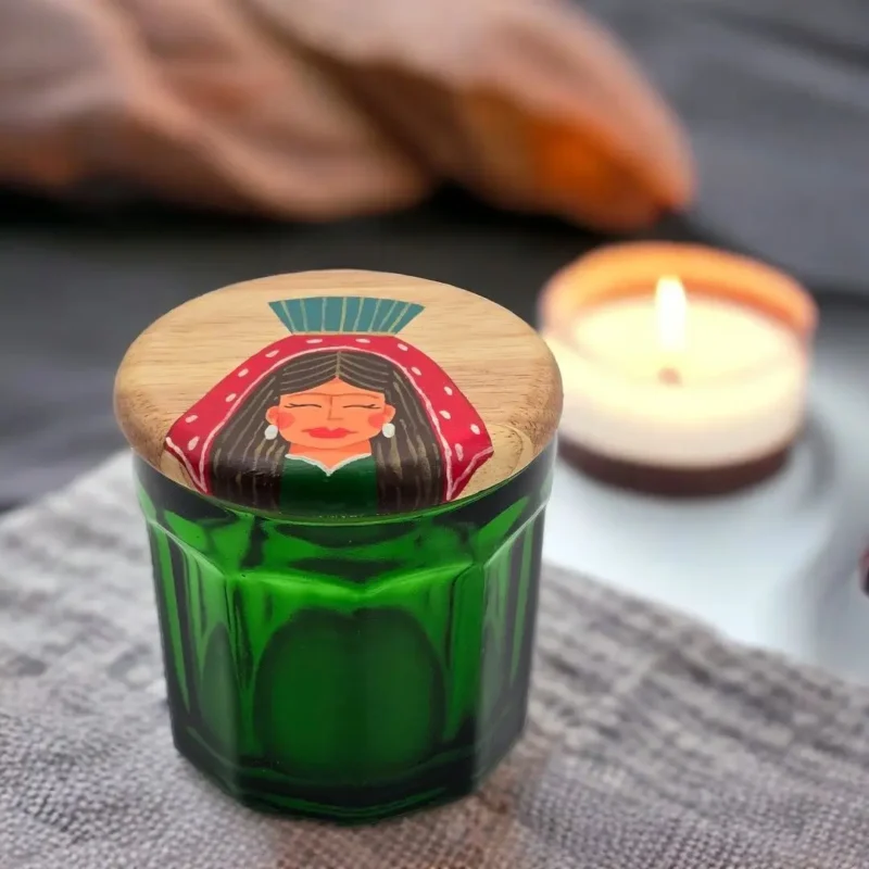 green jar and wooden lid with hand painting