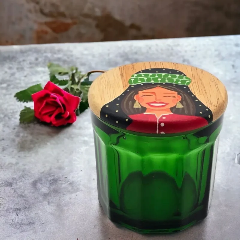 green jar and wooden lid with hand painting